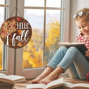 Wooden autumn door sign featuring a maple tree and Hello Fall text, displayed in a cozy indoor setting.