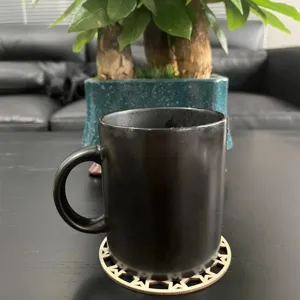 Wooden carved hollow coaster detail showing geometric pattern under black mug for home use.