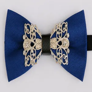 Close-up detail of the elegant blue bow tie featuring gold filigree metal and sparkling rhinestones.