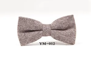 Detailed shot of brown wool herringbone bow tie, vintage winter groom wedding accessory.