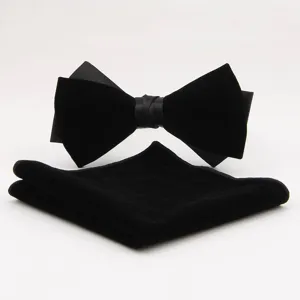 Close-up detail of black velvet bow tie and pocket square set for formal evening events.