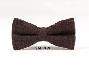 Men's brown woolen bow tie detail closeup, classic tweed fabric for formal events.