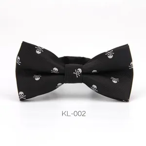 Detailed view of the black men bow tie featuring white skull pattern, close-up texture.