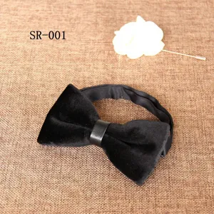 Close up shot of a black velvet bow tie with leather center loop for men suit details.