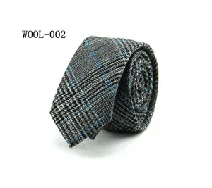 Detail view of a stylish grey wool plaid necktie with blue grid pattern for formal business wear.