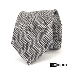 Detalle de corbata clásica para hombre con patrón geométrico en negro y blanco elegante.