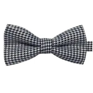Classic black and white houndstooth bow tie for men, elegant British style fashion accessory.