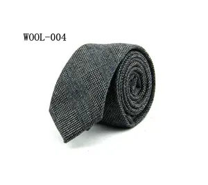 Close-up detail of a stylish mens grey wool plaid necktie rolled up neatly for business attire.