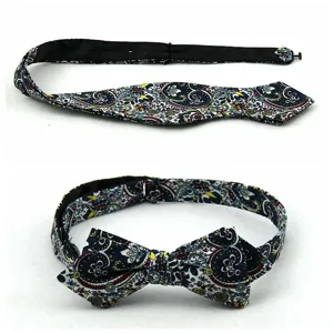 Detailed view of men's floral paisley cotton bow tie, sharp corner self-tie accessory.