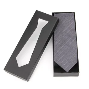 Detail view of grey striped necktie inside black snakeskin texture gift box package.