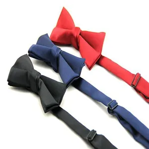 Close up detail of solid color men formal bow ties in black, blue and red with adjustable strap.