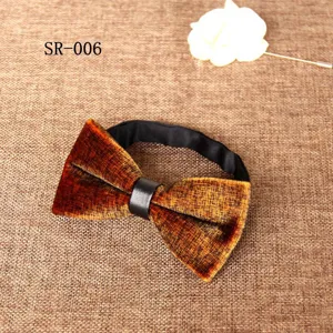 Close-up detail view of the luxury brown velvet bow tie with leather center knot and strap.