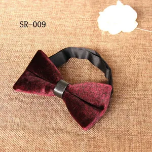 Detailed shot of burgundy velvet bow tie with black leather center accent and textured finish.