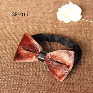 Velvet bow tie detail showing soft brown fabric texture and sleek black leather center knot.