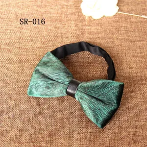 Green velvet bow tie detail, textured fabric close-up, elegant men suit accessory.