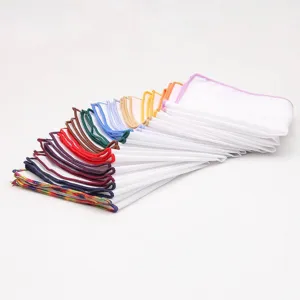 White pocket square detail showing colorful stitched edges folded in a neat fan shape.