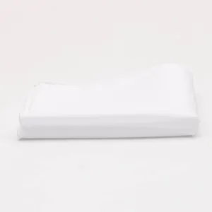 Detail shot of the white pocket square fabric texture, neatly folded cotton accessory.