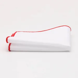 Close-up detail of a classic white men's pocket square featuring a stylish red rolled edge.