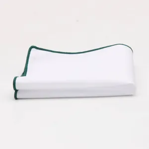 White pocket square detail featuring neat dark green rolled edges for men's formal suits.
