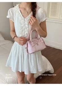 Pink chic women handbag with bow detail, perfect for daily commuting and stylish summer outfits.