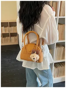 Women fashion bowling handbag detail view, versatile PU leather crossbody shoulder bag.