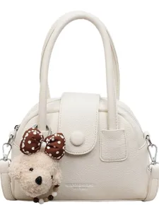Chic white bowling handbag for women with cute plush puppy pendant and bow decoration.