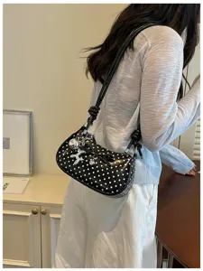 Black polka dot shoulder bag for women, stylish underarm bag with bow and silver dog charm.