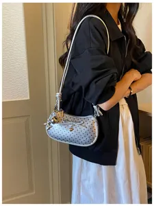 Silver polka dot shoulder bag for women trendy underarm purse with bow and cute charms.