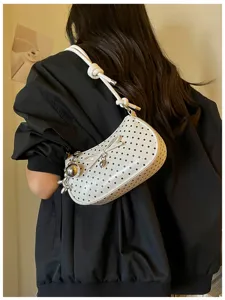 White polka dot shoulder bag with bow and metal pendant, stylish underarm bag for women.