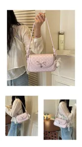 Chic pink polka dot shoulder bag for women, trendy bow crossbody bag with cute heart charm.