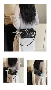 Black polka dot shoulder bag detail showing bow and lace ribbon decoration, lifestyle view.