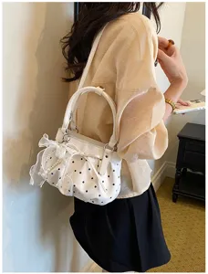 Details of the women white polka dot shoulder bag with cute pearls and bow soft cloud design.