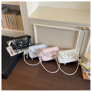 Chic polka dot shoulder bag with bow and lace detail, stylish crossbody bag for women.