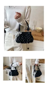 Detail view of the black polka dot pleated handbag with cute pearl and bow decoration.