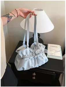 Light blue polka dot pleated shoulder bag detail showing soft texture and chic bow decor