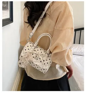 Sweet polka dot lace handbag for women, trendy pillow shoulder bag with cute puppy pendant.