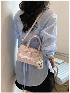 Sweet pink polka dot handbag with lace bow and cute dog pendant for women fashion.