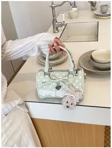 Sweet mint green polka dot pillow bag with lace trim, bow and cute plush puppy keychain.