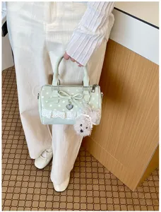 Sweet style polka dot handbag detail, featuring lace trim, cute bow and fluffy puppy pendant.