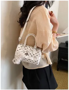 Sweet polka dot barrel bag with lace trim and cute bow. Stylish women shoulder handbag for summer.