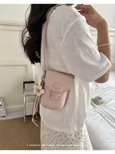 Chic pink crossbody phone bag for women, stylish vintage mini shoulder bag accessory.