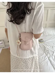 Chic pink leather crossbody phone bag for women, featuring cute flower charm and stylish design.
