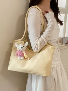 Yellow leather tote bag for women, large capacity shoulder handbag with cute knit pendant.