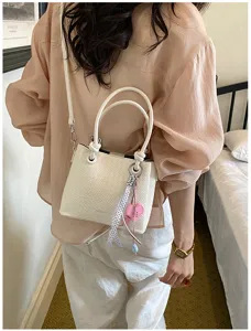 Elegant white woven bucket bag for women, stylish crossbody and shoulder handbag with chic charm.