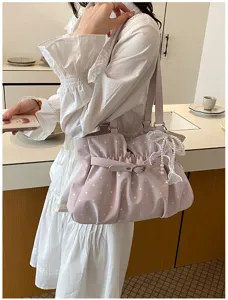 Stylish pink polka dot ruffled shoulder bag for women, versatile fashion underarm handbag.