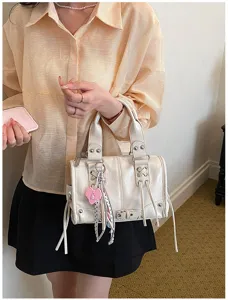 White PU leather Boston handbag detail, edgy rivet straps and cute pink heart charm.
