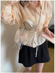 White Boston shoulder bag for women, stylish rivet handbag with tassels and crossbody strap.