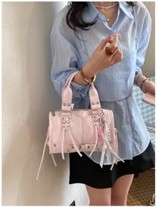 Pink leather Boston handbag for women, stylish vintage shoulder bag with studs and straps.