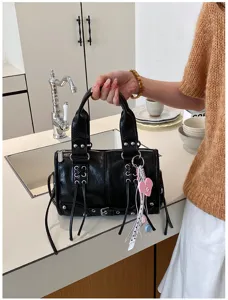 Black Boston handbag commuter shoulder bag with metal rivets and charms for daily use.