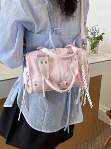 Pink leather Boston bag for women, chic crossbody handbag with top handles and cute ribbons.